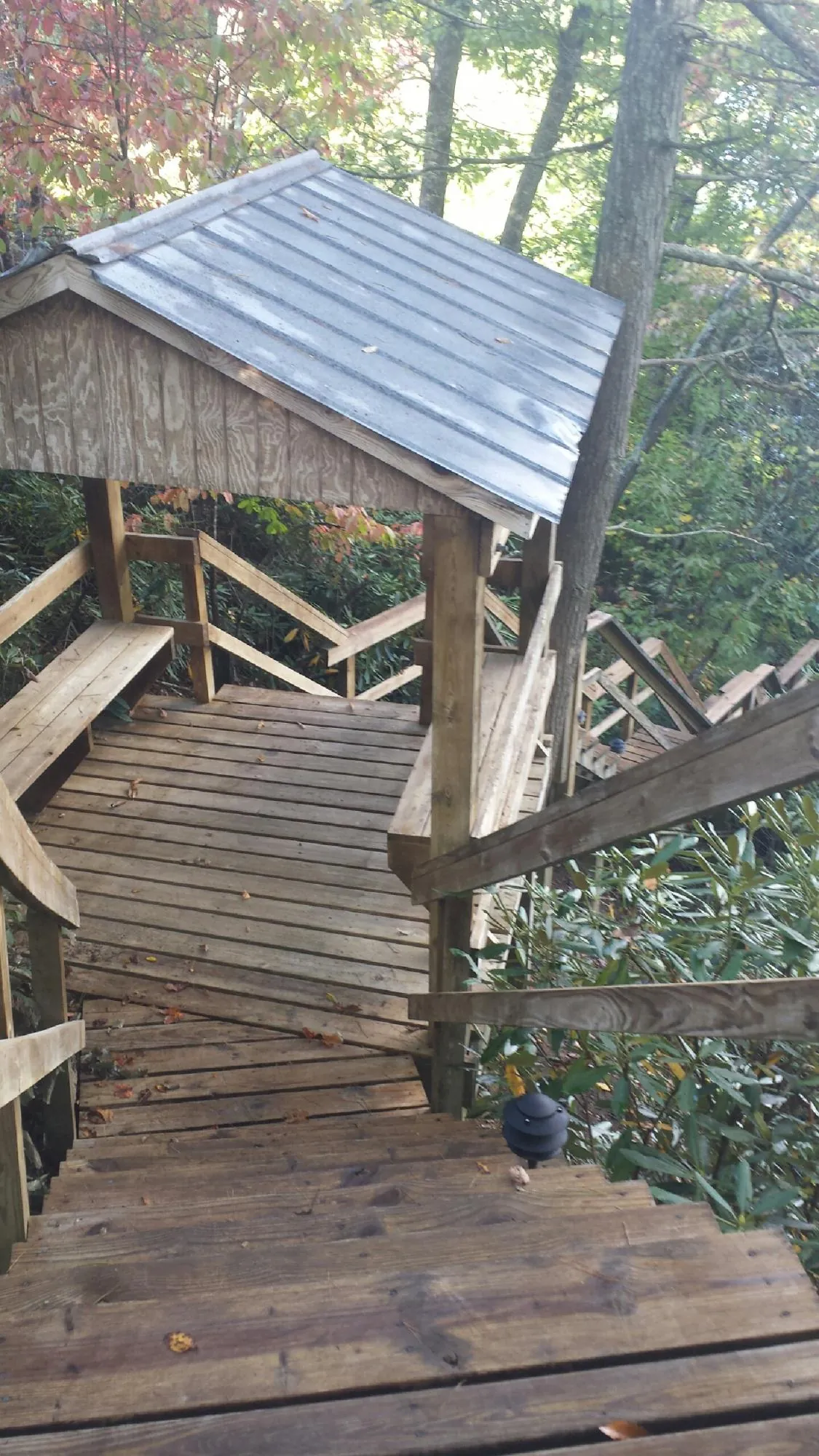 Metal roofed shelter over wooden steps on a wooded walkway — Skylight Repair & Installation work by our crew in Cape Elizabeth